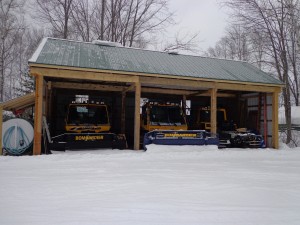 snowmobile trail groomers in new storage barn