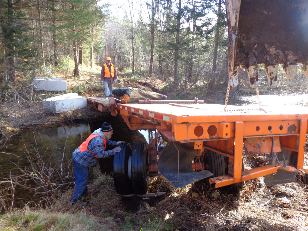 Removing the axle and tires being once we got the trailer to the site. It was originally a tri-axle that we bought for $1700 at an auction....much cheaper than buying steel beams for a bridge and easier to deck.
